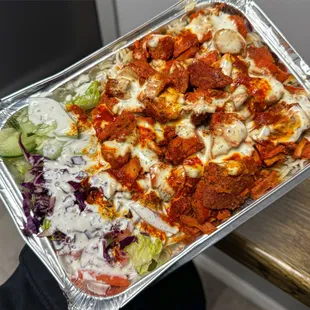 Chicken and rice with spicy and white sauce