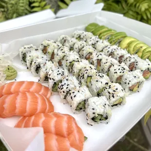 a plate of sushi and avocado