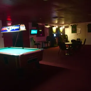 a pool table in a dimly lit room