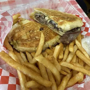 Tri-tip sandwhich with grilled onions, white American  cheese, and aioli.