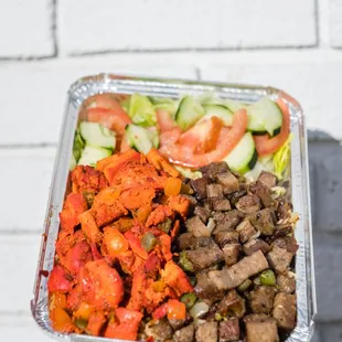 a hand holding a container of food