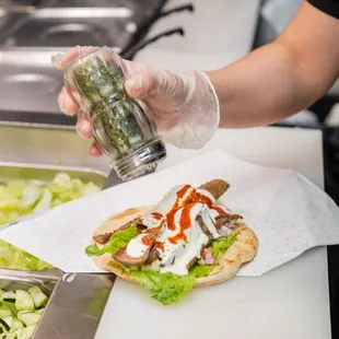 a person in a kitchen preparing food
