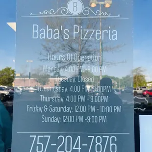 Opening hours posted on door (April 2022)