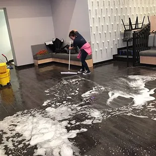 a woman mopping the floor