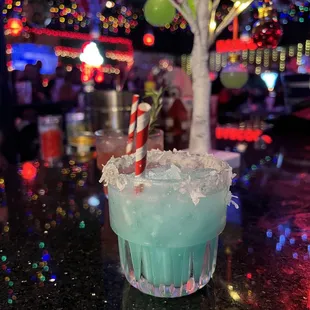 a blue drink with candy canes