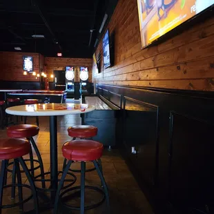 a bar with red stools