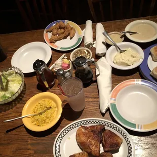 Smoked chicken, chicken strips, mashed potatoes, gravy, biscuits, corn, salad, and green beans.