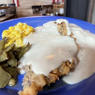 Chicken fried steak with green beans, corn, mashed potatoes and gravy