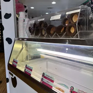 a display of chocolate covered donuts