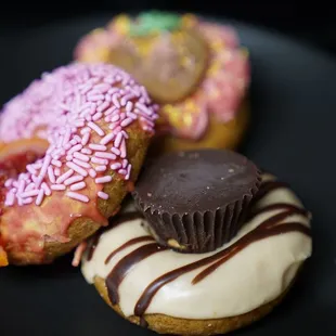 three donuts on a black plate