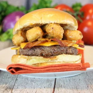 a hamburger with tater tots and cheese