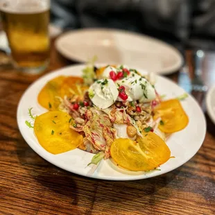 Frisée salad with burrata, fuyu persimmons and pomegranate
