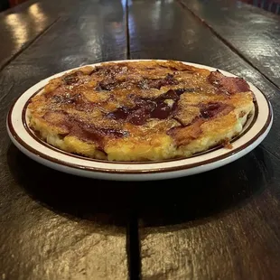 Your choice of crumbled sausage or bacon inside pancake topped with shredded cheese. (Topped with bacon in photo)