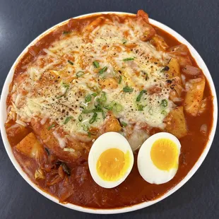 Tteokbokki with cheese and egg. Slightly Spicy. Korean Street Food. Bunsik. Rice Cake. Fish Cake.