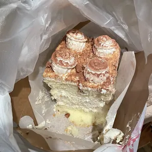 Russian cake (Koko...?) with meringue and a light cream center and candied pecans crushed on top.