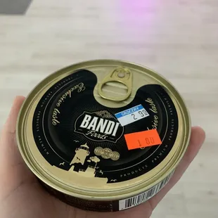 a hand holding a can
