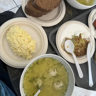 Chicken soup with rye bread and cheese spread. Zucchini pancake