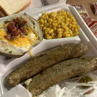 Boudin plate with loaded baked potato and corn