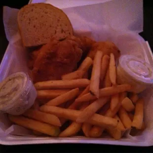 a chicken sandwich and fries in a styrofoam container