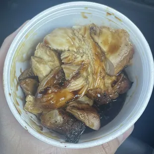 a person holding a bowl of food