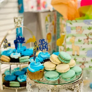 a display of cupcakes and cookies
