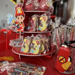 Fire fighter mini dessert bar set up with cookies, cake pops, and chocolate covered pretzels
