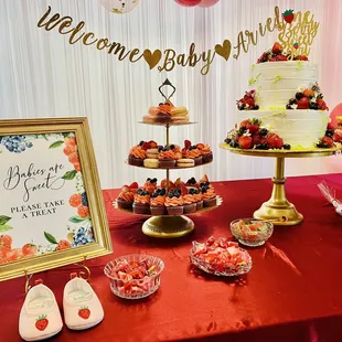 a table with a cake and desserts
