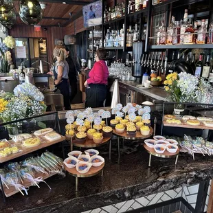 Here comes the sun theme baby shower. Cookies, donuts, and cupcakes by Erika