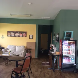 a living room and kitchen with a refrigerator
