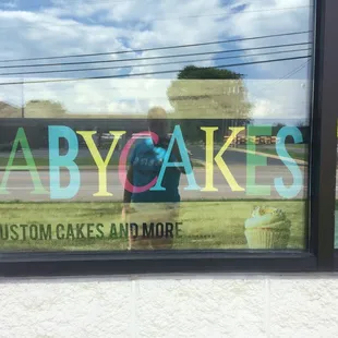 the reflection of a person in the window