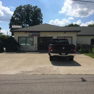 a pickup truck parked in front of a store