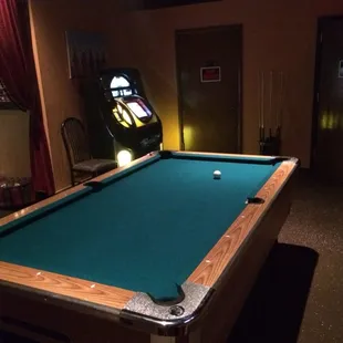a pool table and a pinball machine