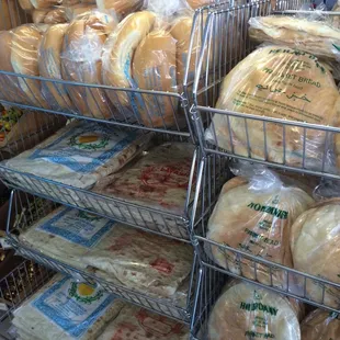 a person picking bread from a rack