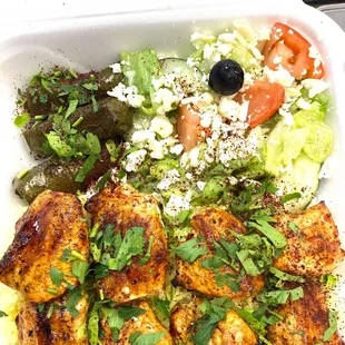 Shish tawook with rice and greek salad and grape leaves