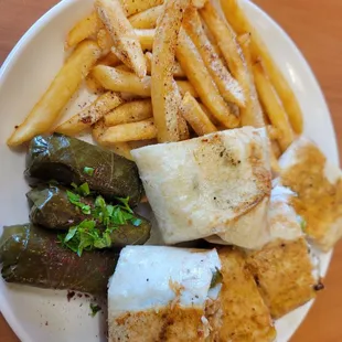 Chicken shawarma with fries and grape leaves