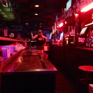The single bartendress is very busy