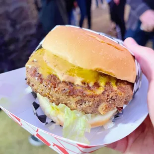 a hand holding a sandwich