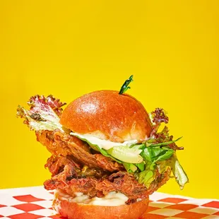 a burger on a checkered napkin