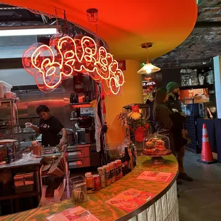 a neon sign above the counter