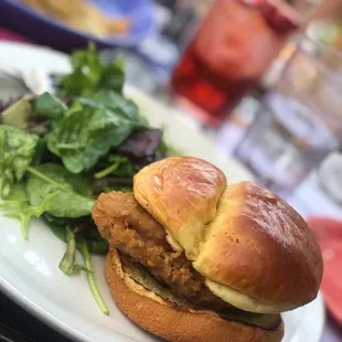 a chicken sandwich and salad on a plate