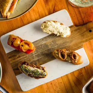 a wooden cutting board with a variety of food on it