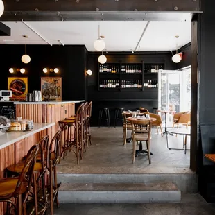 a view of a bar with wooden chairs