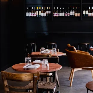 the interior of a restaurant with tables and chairs