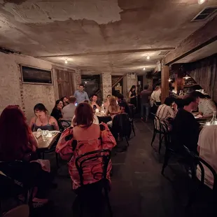 a large group of people sitting at tables in a restaurant