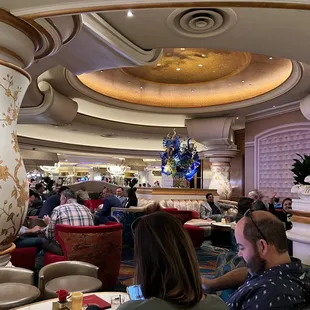 people sitting at tables in a restaurant