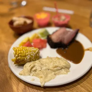 Mashed potatoes corn fruit prime rib