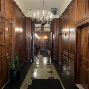 a hallway with chandeliers