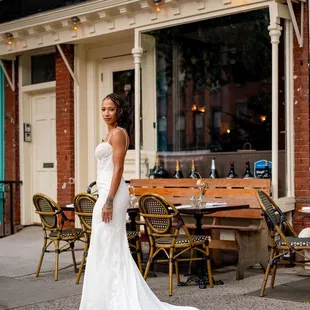 a bride standing in front of a restaurant