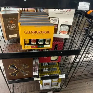 a shelf of wine bottles and wine glasses