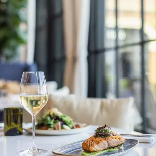 a plate of food and a glass of wine